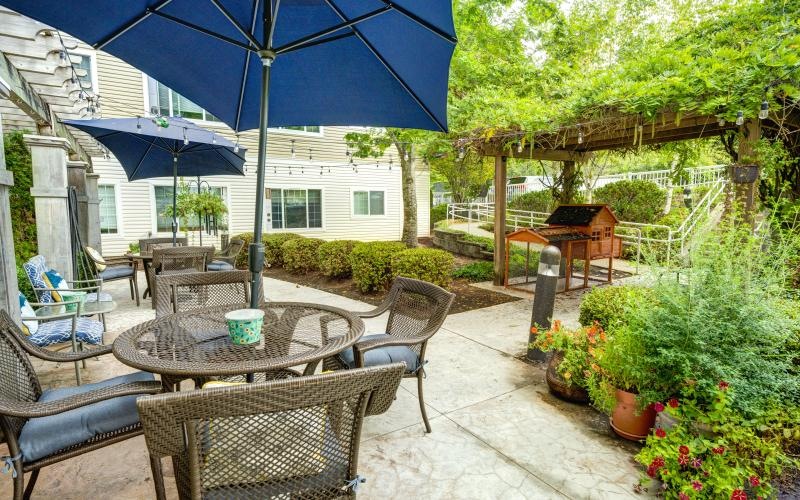 a patio with tables and chairs